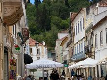 View up Rua Serpa Pinto, the Main Street of the old town, looking up to the castle