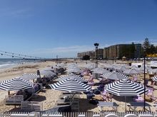 The preparation for concert, stage being set up on beach. 