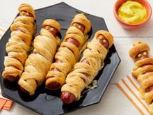 Crescent roll strips wrapped around hot dogs.  