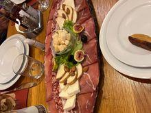 Starter of meat, cheese, bread, and dips