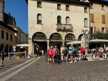 The area is popular with cyclists because it features the same array of terrains encountered in major races. Here, some riders have paused their training to drink from and take a group photo in front of the winged lion fountain in Piazza Garibaldi