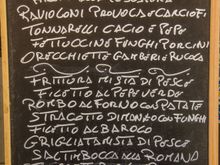 Local menu. We try to seek out places to eat where the clientele is mostly locals. No easy task, let alone directly across from a major tourist attraction. Yet incredibly, Hosteria Cannavota fit that bill perfectly! We snagged the last seat during that pre-Easter weekend. Rock fans: the young waiter was a dead-ringer for a young Jimmy Page!  