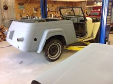 Half primed and probably my last view of the butter yellow paint. DH wants a dark red with cream trim.