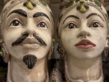 Testa di Moro.....if you saw THE WHITE LOTUS you know the this love story of a male Moor with a local lady.   Particularly popular in Palermo which was more influenced by the Moors than the eastern part of the island.   The better example of these ceramics cost well into the hundreds of euro..they come in all colors and sizes and quality of workmanship...I liked the colors in this pair but would think they are in the middle realm of quality..priced at a bit over 300 euro per piece.