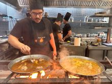 Cooking the rice over orange wood at Llisa Negra, Chef Quique Dacosta's  Valencian rice temple