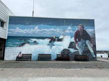 Mural of Claudina, a beloved "percebeiro," gatherer of percebes (goose barnacles).   This is an interesting article about the hazards of this profession, and you can watch videos of gathering these delicacies on YouTube;
https://roadsandkingdoms.com/2016/barnacle-queens-of-the-seaside/