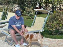 Guest with one of the masseria's three gentle dogs