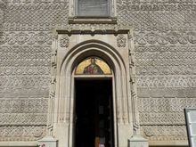 The exterior is carved all over with chevrons, meanders, and rosettes. Very intricate. Looks like lace.