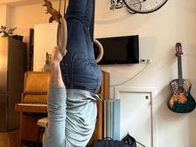 The supportive spouse playing on the rings in the apartment (the owners’ kids play with them when the apartment isn’t rented). 

