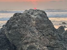The sun resting on a rock