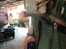 View up the side of our casa - my wife had a zinc tile roof built over the entire length of our casa on one side to keep the rain off of our generator (covered) and everything else there too throughout that passageway. 