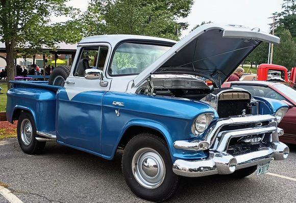 Close up of our truck. The curved windshield required three guys and several hours to properly install after painting. It's the only antique dh has that has working windshield wipers. A lot of people put hoods up so engines can ne inspected.  The GMC has a newer engine.