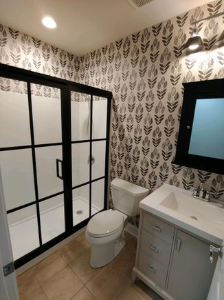 
Small footprint bathroom but feels larger with a narrower vanity, white shower to replace tub/shower, new lighting, custom medicine cabinet.  Floor is much grayer IRL, it’s a mix of beige, gray and white. No idea where the light rusty color is coming from! 