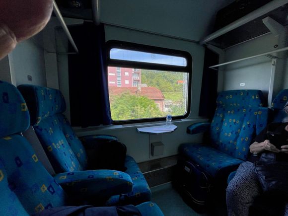 Looking out the window.  There was some air conditioning and you could open the window above the picture window. Plenty of storage overhead for our bags