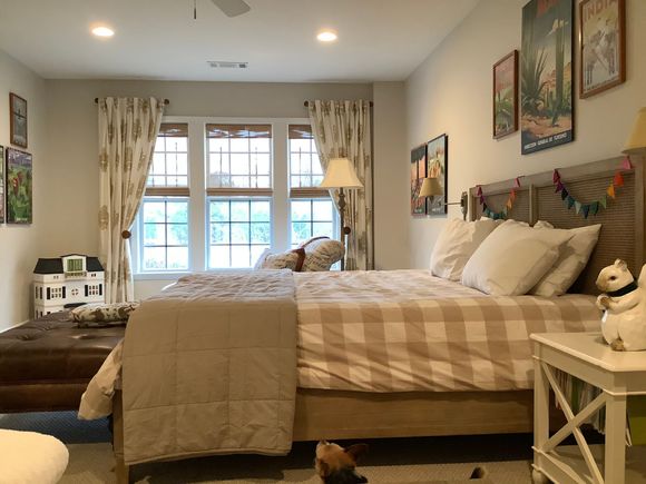 
Room with massive ottoman at foot of bed.