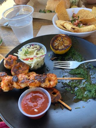 This was the best shrimp I have ever eaten in my life, perfectly grilled and served with a salsa verde, grilled lemon, wonderful coleslaw. Also in the upper right is rockfish ceviche. My wife had a perfectly cooked grilled swordfish sandwich. Great meal at Mitch’s. Also, though it’s a shack type of place there are real dishes and silverware, which really enhances food. If parking were not such a PIA I’d eat there repeatedly.

Great beer menu too but it was a bit early for us.



