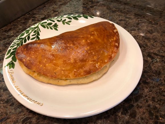 Calzone with pepperoni, ham, Italian sausage, mushrooms and mozzarella 