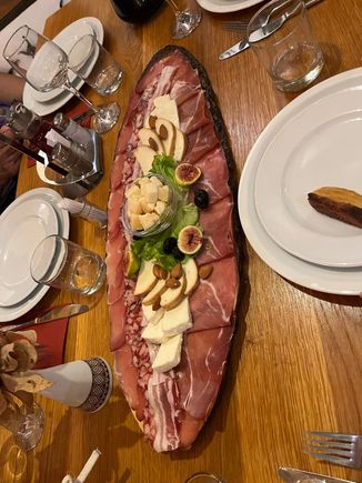 Starter of meat, cheese, bread, and dips