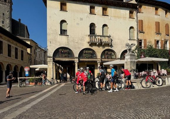 The area is popular with cyclists because it features the same array of terrains encountered in major races. Here, some riders have paused their training to drink from and take a group photo in front of the winged lion fountain in Piazza Garibaldi