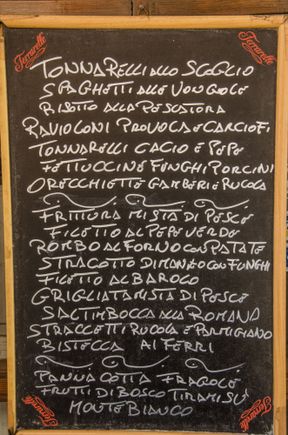 Local menu. We try to seek out places to eat where the clientele is mostly locals. No easy task, let alone directly across from a major tourist attraction. Yet incredibly, Hosteria Cannavota fit that bill perfectly! We snagged the last seat during that pre-Easter weekend. Rock fans: the young waiter was a dead-ringer for a young Jimmy Page!  