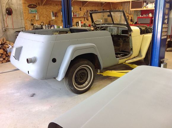 Half primed and probably my last view of the butter yellow paint. DH wants a dark red with cream trim.