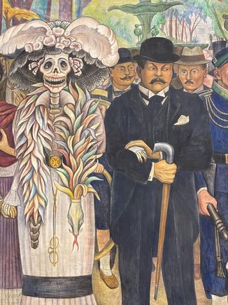 The Catrina with it's creator Jose Guadalupe Posada.  Originally the Calavera Catrina was only a head with the large hat.  Diego added the body in  1946-47, and the rest is history