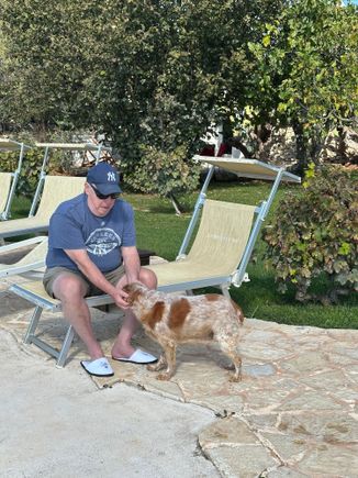 Guest with one of the masseria's three gentle dogs