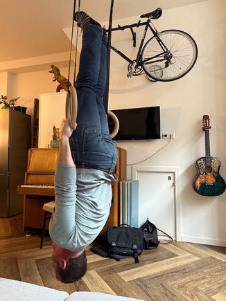 The supportive spouse playing on the rings in the apartment (the owners’ kids play with them when the apartment isn’t rented). 


