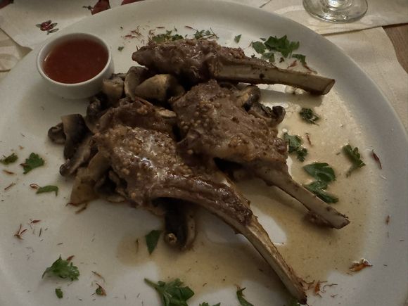 My lamb chops sitting on a bed of sauteed mushrooms. A very disappointing meal. 