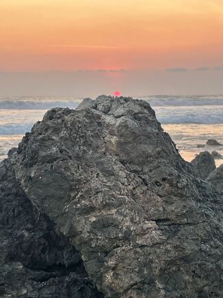 The sun resting on a rock