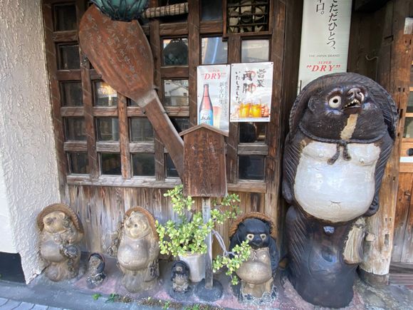 A tanuki, a common sight throughout Japan. A tanuki is an animal, a raccoon dog, and is thought to have magical powers and is an important part of folk culture. It’s said to bring good luck. 