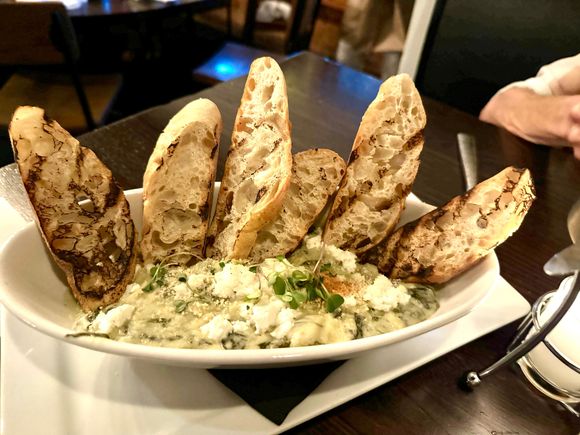 Appetizer of goat cheese, artichokes and spinach 