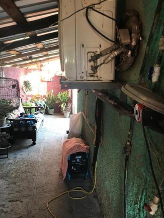 View up the side of our casa - my wife had a zinc tile roof built over the entire length of our casa on one side to keep the rain off of our generator (covered) and everything else there too throughout that passageway. 
