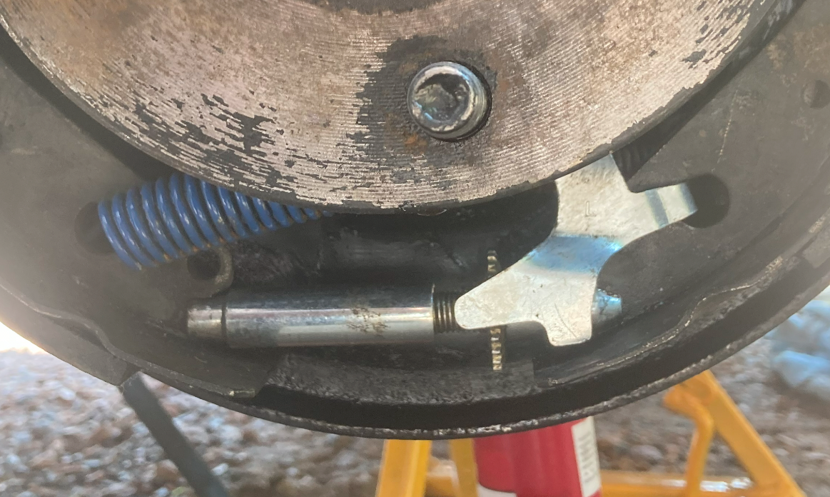 Without consideration to anything else, this here is an example of poor quality aftermarket parts , this is the rear drum on my 1996 with aftermarket adjuster parts. See how that lever is not horizontal and in line with the screw thing?   That would, if you kept using it, lock up too.  The shoe question above is also important