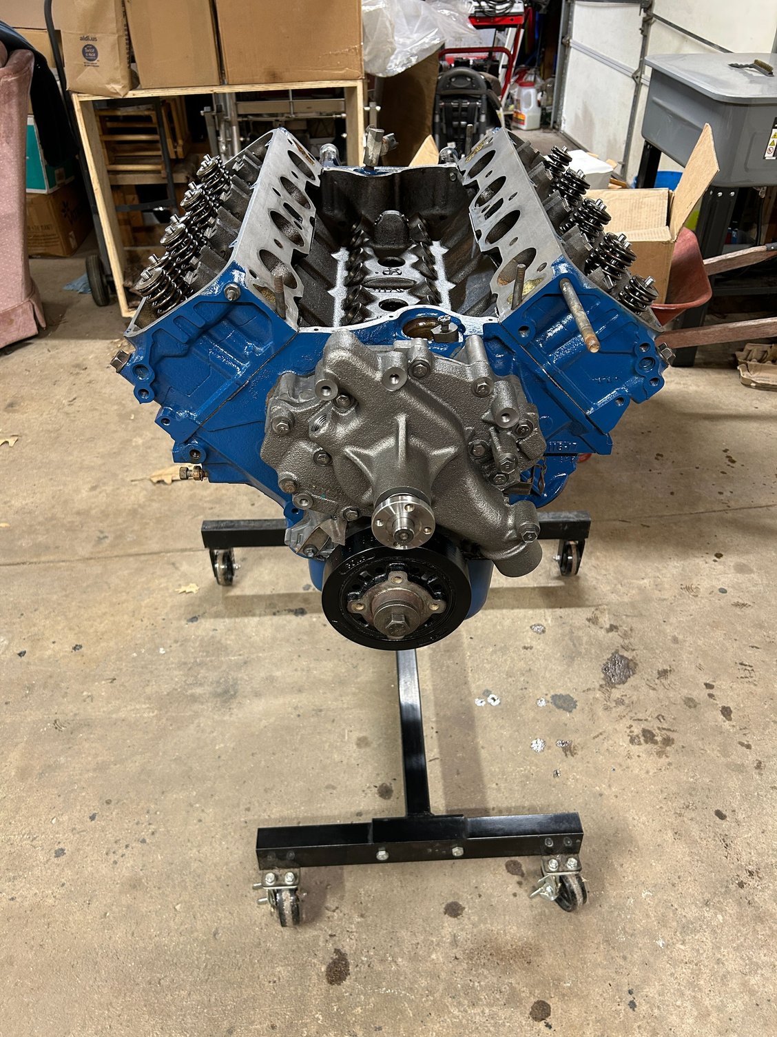 When I got the water pump installed with the new gaskets that came with it, they looked better than the ones that came in my overhaul kit, so I went with them. And then, as you can see in the picture, I got the heads install installed and torqued down. And at this point, I was gaining motivation to keep going. I wanted to get this thing buttoned up to keep the dust out of it. I installed the harmonic balancer, but did not torque it down just gave the crankshaft a couple of rotations. 