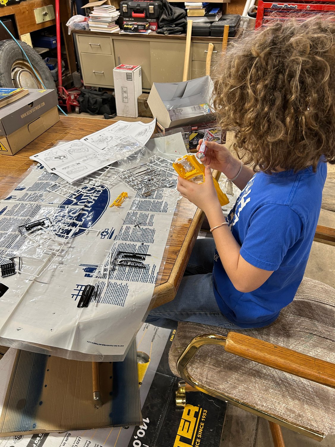 Helped my middle boy get set up real quick and got him situated to where he could continue working on his model. And then just as I was getting ready to knock some freeze plugs out my oldest boy came out, so I handed him the punch and hammer and made him do it. And I showed him how to knock him sideways so that we could pull them out with a pair of pliers