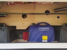 This is what the front storage compartment looks like with the covers on to protect all of the electronics and still allow us to use the space. Also our 1000w generator that will run the A/C or charge the batteries when boondocking over multiple rainy days.
