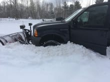 Even with 1100+ pounds of ballast and chains on the rear, I still managed to get stuck plowing out a lot that had been untouched all winter.