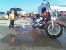My daughter (3 at the time) helping me wash up the hog before a ride up to deadwood.