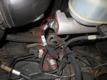 wiring on the master brake cylinder. the one circled red, on the end. there is a recall on this. somehow fluid leaks into this and it shorts out. fords wisdom to tie it into the cruise control?