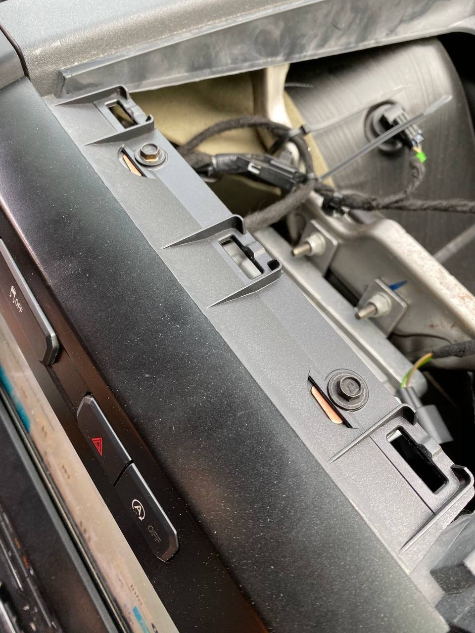 3 clips in front, 2 screws towards the windshield. For the top tray. Totally spaced on that picture apparently.