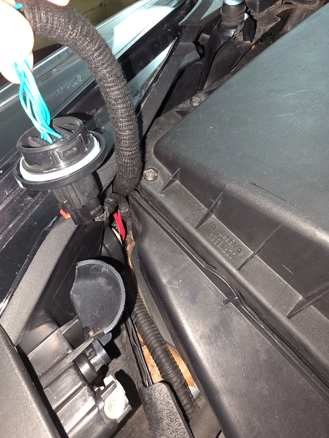 Does anybody else have this plug adapter on their headlight assembly? The driver side doesn't have it just the passenger. The passenger side headlight assembly has been changed. The passenger side blinker blinks fast. The headlight assembly was changed before i bought the car.  2018 Cadillac xts 