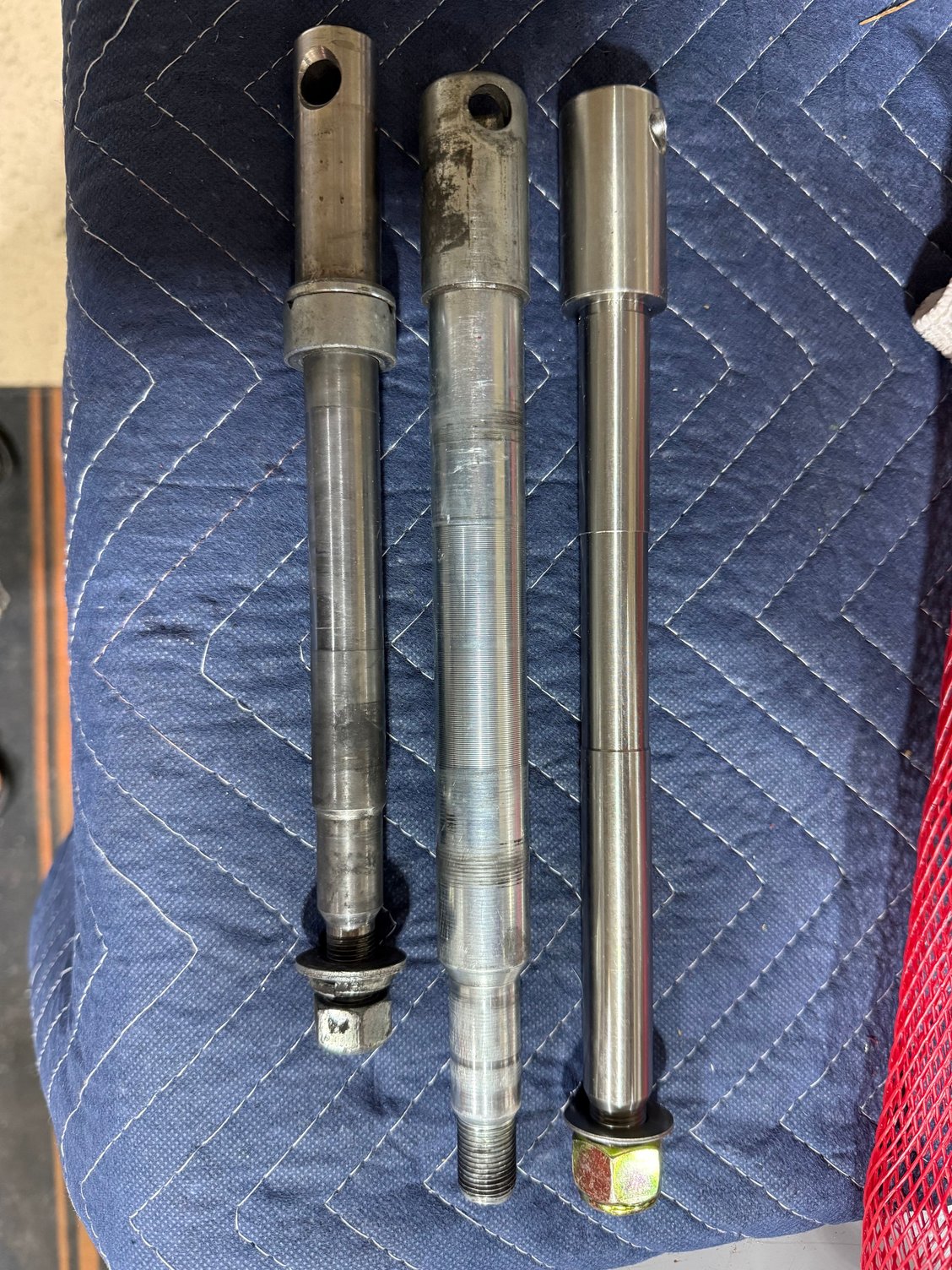 Stock FXD axle on left, Stock 49mm axle in middle, and the Vulcan conversion axle on the right. Definitely going to need some spacers. 