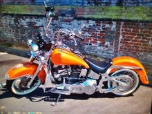 So I made a few changes to the Fatboy since I posted last. Stretched 5 gal tanks, smoothie rear fender, and Kandy Tangerine paint w/graphics.