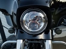 I put one from eagle lights in my streetglide, 6k color temp, i believe Harley daymaker is 5k.  During the day I run high beam and get flashed by cars because its so bright, I'm good with that because thats means they see me!  Both beams stay on when on high.  At night this light is crazy bright and the path is very wide into the trees on the side of the road.