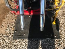 6 year old thread but here is what i did on my buddies Road King. I used 3m headlight restorer and then used mothers on it. Turned out really good as you can compare the one fork that is not done to the other that is in first picture 