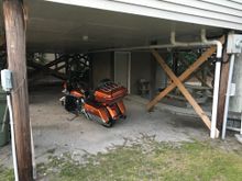 Saturday night parking spot.  This is at our house, if you zoom in you can see the paving block that I have to keep kickstand from sinking in sand.   And also the "Harley Davidson Parking" sign on the cross bracing.   Made for bike parking!