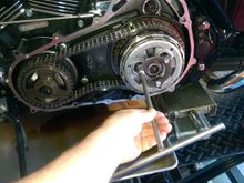 Loosen 3 screws each 1 to 2 turns at a time.  You want to remove pressure evenly.  If you don't you can break the bolt standoffs on the clutch hub. 