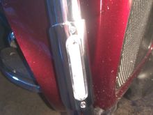 There's a clear cover under the entire polished stainless piece, and it's got silicone all the way around to seal the assembly.  The wiring hole got gooped, too.  Then the metal piece pops on over that, and is secured with the screws.