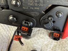 If you are building a connector you will remove the seal from the connector, slide the wire through and install a pin. After you seat the pins in the connector put a little dielectric grease on the edge of the seal and on the wire towards the pin. Then slide the seal into the connector. 
